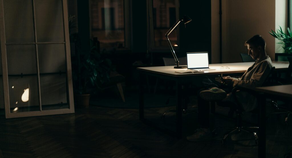 man making money from phone at night focused
