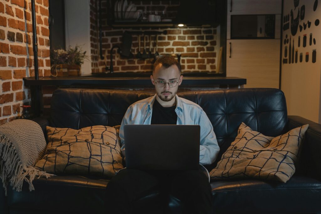 man building passive income streams on laptop at night