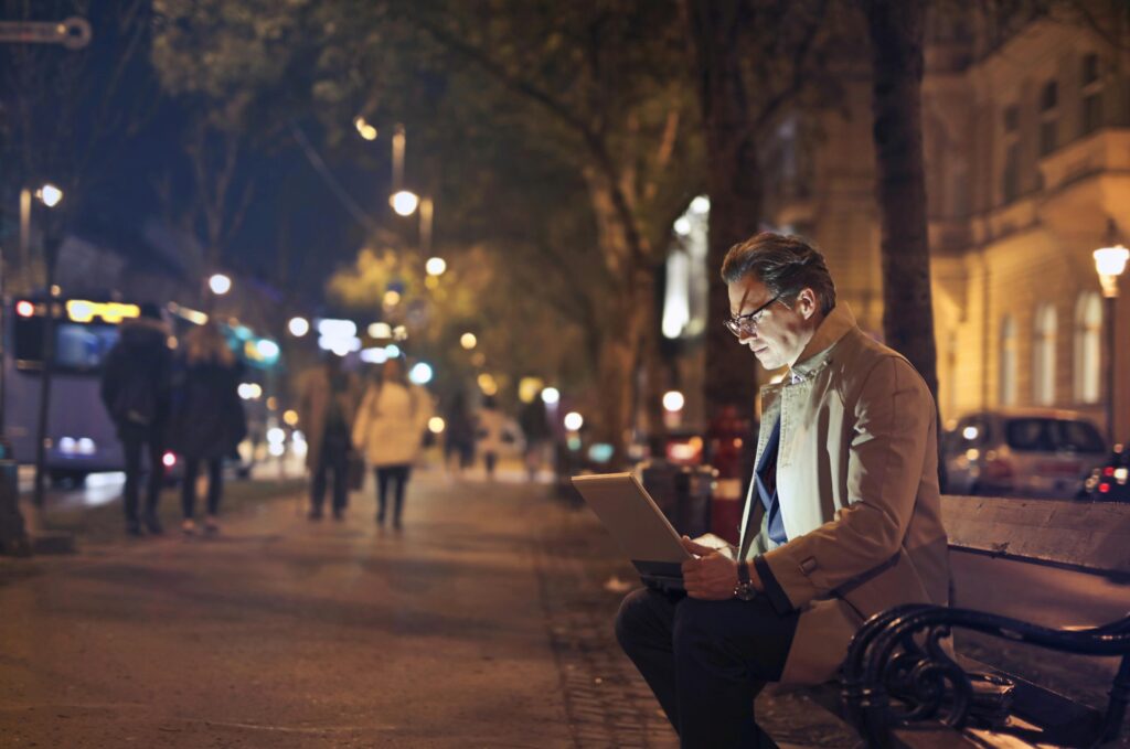 man working late at night on laptop side hustle