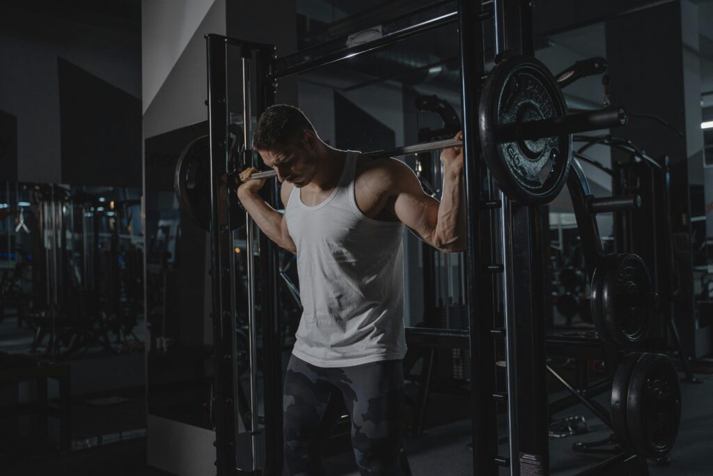 man lifting weights gym workout split training